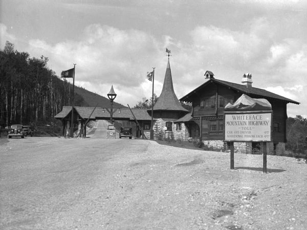 View of the Whiteface Mountain Highway Toll Station, and three cars parked nearby.