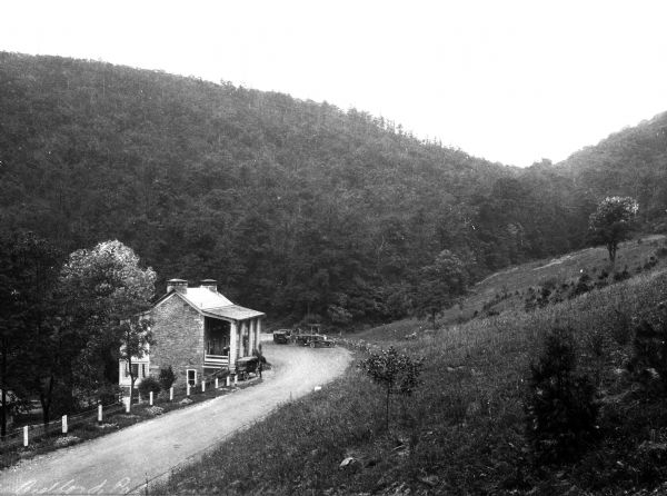 View down hillside toward the Lincoln Highway and a Revolutionary War shot factory, surrounded by woods and hills.