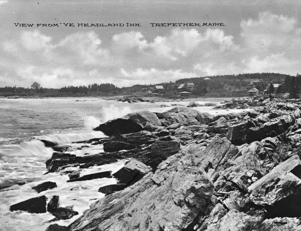 View along rocky coastline with crashing waves. Buildings are along the shoreline in the distance. Caption reads: "View from Ye Headland Inn. Trefethen, Maine."