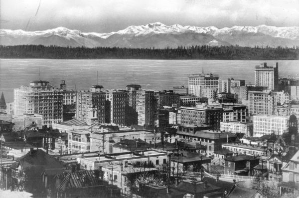Elevated view of the city from Capital Hill, with the Puget Sound and the Olympic Mountains in the background.