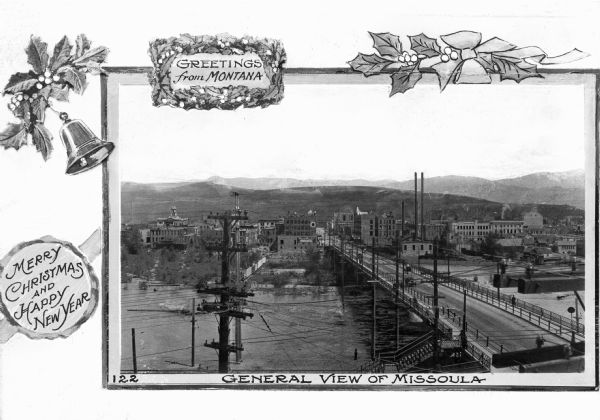 A Christmas greeting card featuring a view of the city, including a bridge over the Clark Fork river, numerous industrial-style buildings, and telephone poles and cables.  The captions read, "Greetings from Montana," "Merry Christmas and Happy New Year," and "General View of Montana."