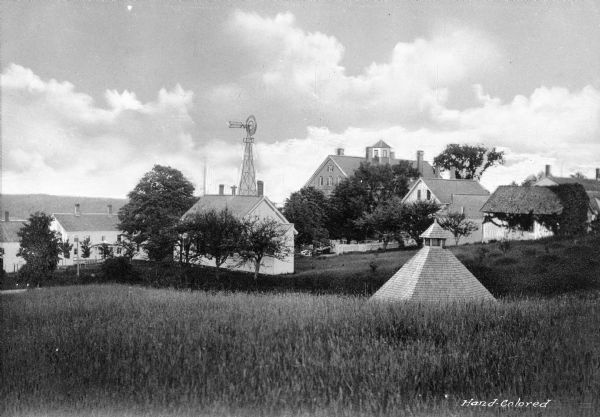 View toward the Shaker community, which was organized in 1794. Included are a few of the Shaker buildings and a windmill.