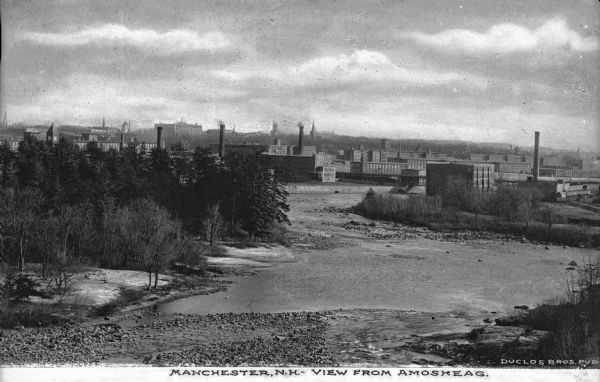 Distant elevated view of Amoskeag textile mills and the Merrimack River. Caption reads: "Manchester, N.H. - View from Amosheag."