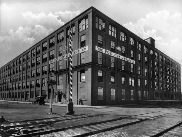 View of Pexto building with railroad tracks in foreground. Pexto, the Peck, Stow and Wilcox company, manufactured hardware.