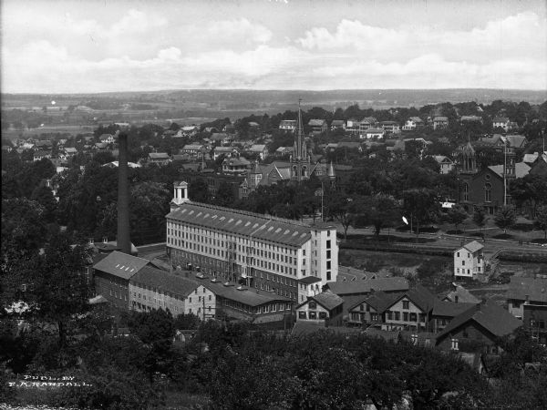 Elevated view of a factory building and surrounding town.