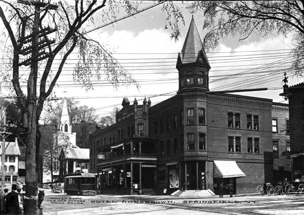 View of Hotel Adnabrown from across the street including other surrounding buildings and a streetcar. Caption reads: "Hotel Adnabrown, Springfield, VT."