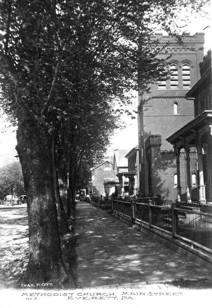 View of the Methodist church on Main Street from the sidewalk. Caption reads: "Methodist Church, Main Street, Everett, PA."