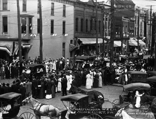Elevated view of a parade on a main city street during Chautauqua Week. Caption reads: "Chautauqua Week, Somerset, PA."