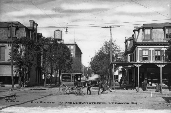 The 7th and Lehman Streets intersection with a horse-drawn delivery carriage and a drugstore on the corner. Caption reads: "Five Points * 7th and Lehman Streets, Lebanon, PA."
