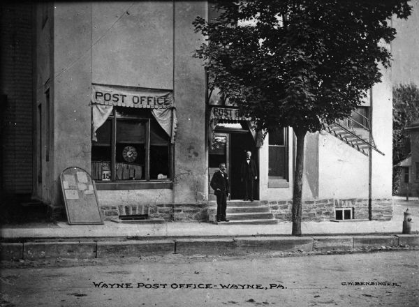View of Post Office from the street with two men standing in front. Caption reads: "Wayne Post Office, Wayne, PA."