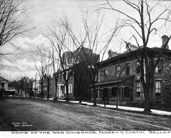 Home of the War Governor, Andrew G. Curtin. View down a street lined with large homes with carriages in front. Caption reads: "Home of War Governor, Andrew G. Curtin, Bellefonte."