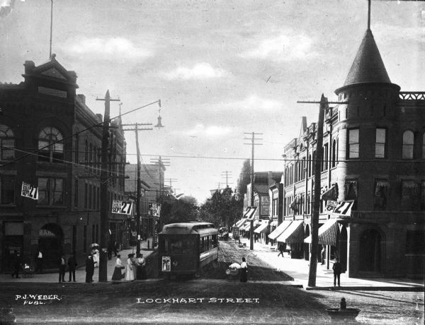 Lockhart Street with banks on opposite corners, featuring foot traffic and a trolley. Caption reads: "Lockhart Street."