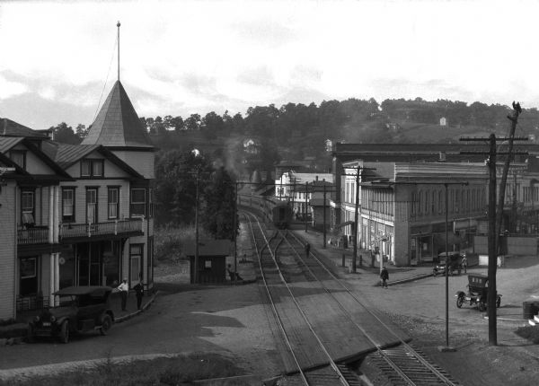 Elevated view of the business section of town with the Manhattan Hotel and railroad station.