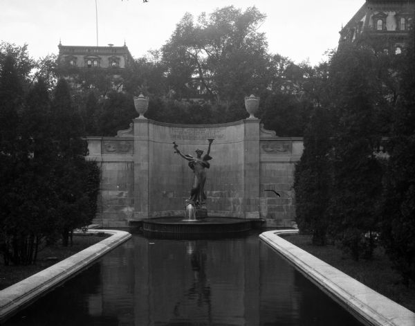 A monument entitled "The Spirit of Life" dedicated to the memory of the financier and philanthropist, Spencer Trask, that features a statue, a stone wall and a fountain with a reflection pool.
