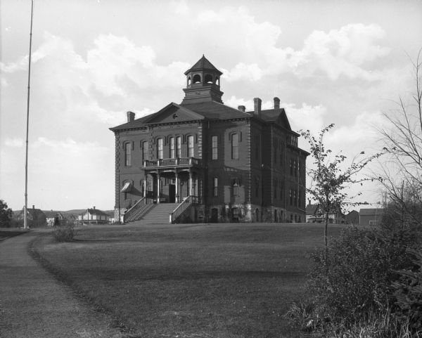 Exterior view of the Valley City courthouse and the path leading up to it. Homes and other structures are visible in the background.