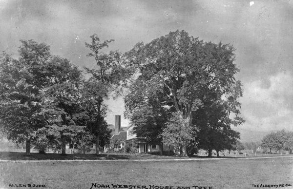 View toward the Noah Webster House, the home of American lexicographer Noah Webster, the author of the first American dictionary (1828), probably built circa 1748 as part of a 120-acre farm. A path is in front of the trees and house. Caption reads: "Noah Webster House and Tree."