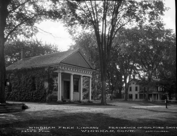 A view of the Free Library, and the home of Guilford Smith in the background on the right. No other building are visible. Caption reads: "Windham Free Library. Residence of Guilford Smith. Windham. Conn."