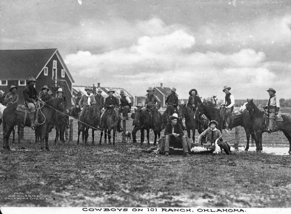 Group portrait of cowboys with a roped steer. In the background are farm outbuildings. On the other side of the fence behind them is a dog.  Most men are on horseback, except for the two posing with the steer and two other people. Caption reads: "Cowboys on 101 Ranch. Oklahoma."

In 1975 the ranch was designated as a National Historic Landmark.