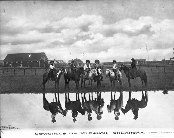 View across water toward six cowgirls on their horses, with their reflection in the water. Ranch outbuildings are in the background. Caption reads: "Cowgirls on 101 Ranch, Oklahoma."

In 1975 the ranch was designated as a National Historic Landmark.