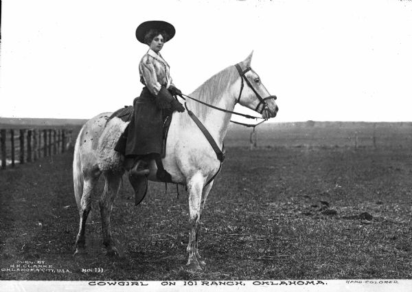 Portrait of a cowgirl sitting on a horse. A fence runs along the left, with an open field in the background. Caption reads: "Cowgirl on 101 Ranch, Oklahoma."

In 1975 the ranch was designated as a National Historic Landmark.