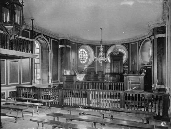 A view of the general court's restored interior in the colonial capitol. The view is taken from the viewing benches, with the focus on the judges' podium.