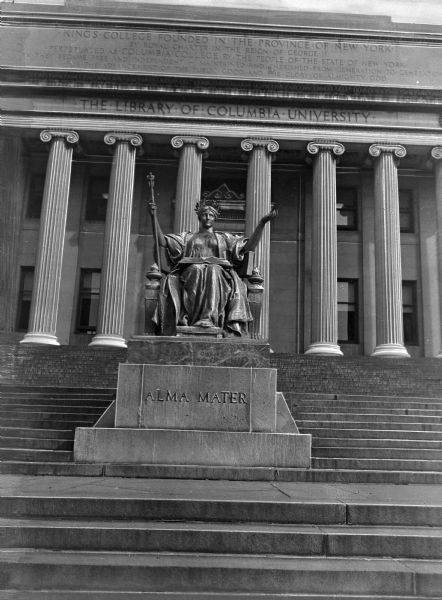 The Alma Mater statue in front of the main library. Both the building and statue have features of the Classical style, including a laurel wreath and decorative urns on the sculpture and columns on the library.