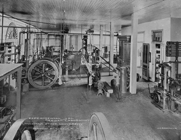 A view of various machines arranged within the experimental mechanical laboratory at Louisiana State University. Printed in the bottom center: "Experimental Mechanical Laboratory Louisiana State University Baton Rouge, LA." Printed in the bottom right: "J.A. Anderson."