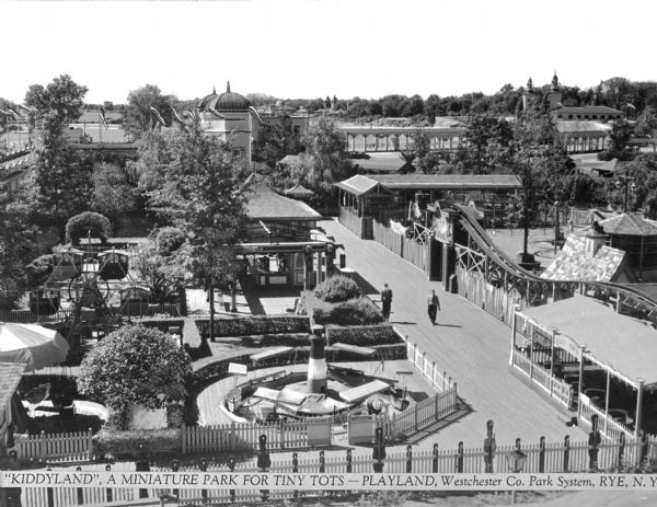 Elevated view of Kiddyland at Playland. The area features miniature amusement park rides for smaller children, including a miniature Ferris wheel and a boat ride in the left foreground. Caption reads: "'Kiddyland', a Miniature Park for Tiny Tots -- Playland, Westchester Co. Park System, Rye, N.Y."