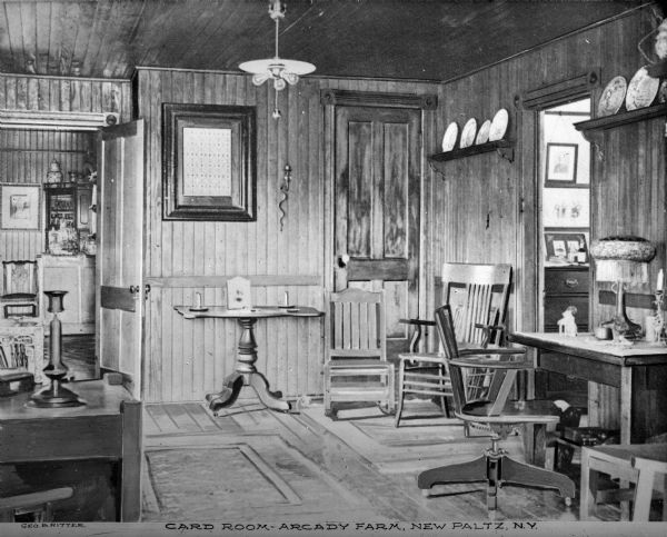 The Card Room, which has wood paneling and heavy furniture. Doors on either wall open into adjoining rooms. Caption reads: "Card Room — Arcady Farm, New Paltz, N.Y."
