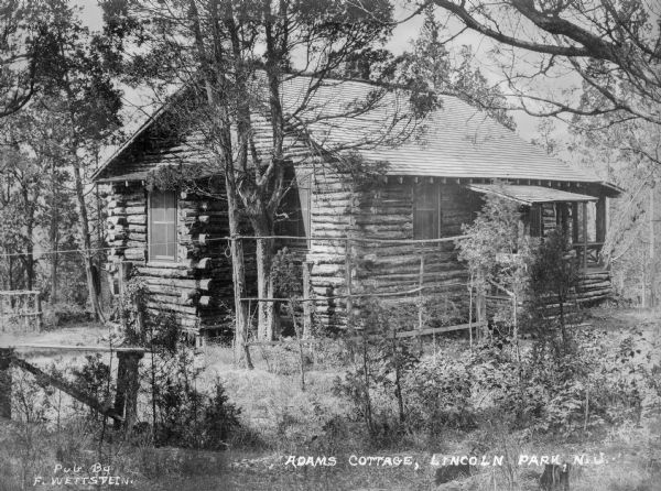 Exterior view of Adam's Cottage, surrounded by trees. Caption reads: "Adams Cottage, Lincoln Park, N.J."