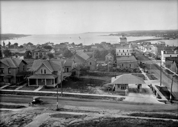 Elevated view of Sturgeon Bay. The commercial strip and domestic buildings are in the foreground.