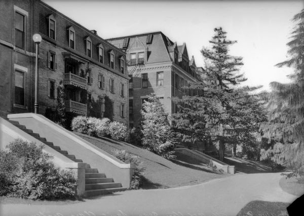 A view of the main buildings at Saint Clara Academy, set against a hill. Saint Clara Academy operated as a boarding school until 1969, when it transitioned to being a day school, and eventually closing.