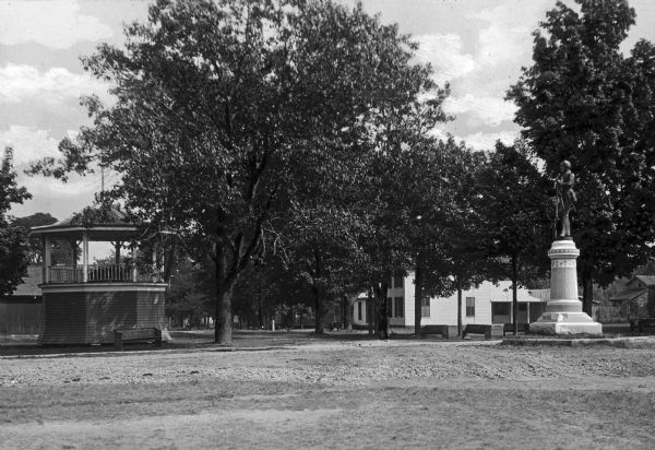 A view of a park with benches, a gazebo, and a Civil War soldiers monument. The monument was dedicated on July 4, 1901.