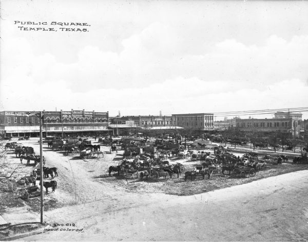 Elevated view of horses and carts on a public square. Business signs read: "Kyle's Furniture" "Brady & Black Hardware Co." "SHBRR" "R.L. McKnight Grocer" "Coca-Cola" "Jarrell's New Mississippi Store" and "Daniel and Jarrell Furniture." Caption reads: "Public Square, Temple, Texas."