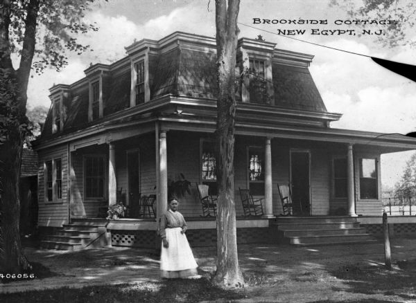 A woman is pictured standing in front of Brookside Cottage, a large country-style home. Caption reads: "Brookside Cottage New Egypt, N.J."