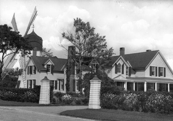 View of the residence of S.P. Nash. Behind the home is a large decorative windmill.
