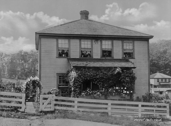 Front view of home and garden, with ivy covering the front porch, in a company town of Consolidated Coal Company.