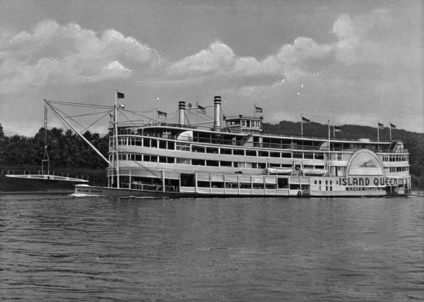 View of the steamship "Island Queen," near Coney Island, which is on the Ohio River near Cincinatti. "Island Queen Coney Island" is painted on the rear of the ship, and "Island Queen" is on the front of the ship. Passengers are on the ship decks.