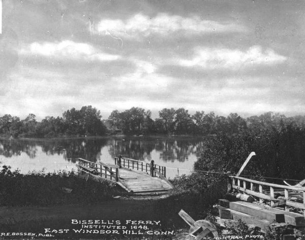 View of Bissell's ferry landing on the river at the shoreline. Caption reads: "Bissell's Ferry, Instituted 1648. East Windsor Hill Conn."