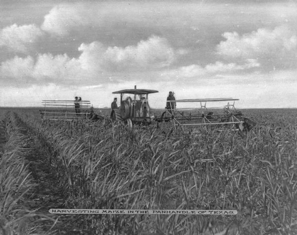 Three men harvesting maize (corn) in the Texas panhandle. A tractor and other farm machinery is being utilized. Caption reads: "Harvesting Maize In The Panhandle Of Texas."