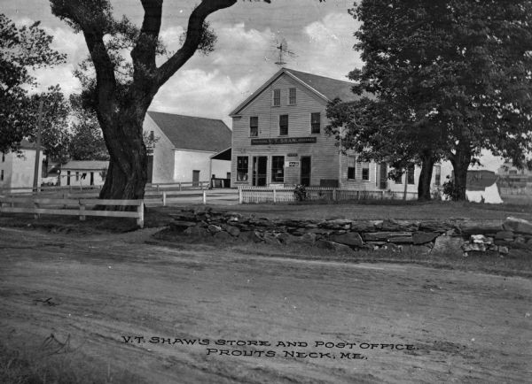 Exterior view of V.T. Shaw's store and post office. A weather vane is visible on the roof of the building. Caption reads: "V.T. Shaw Store & Post Office, Prouts Neck, ME."