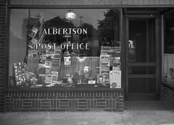 Exterior view of the Albertson Post Office with books displayed in the window.