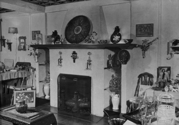 Interior of a small gift shop with items arranged around a fireplace and hearth.