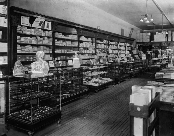 Interior of J.M. Stearns Book & Stationary Store. Pens, books, and printing supplies are on display.