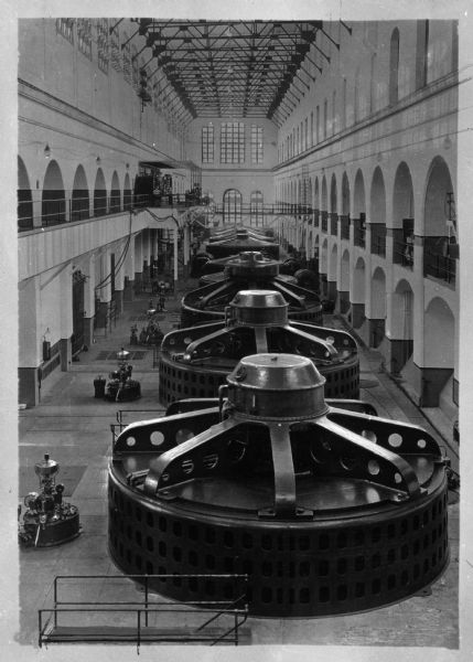 Interior view looking down from balcony of the Penn Light and Power Company, and what appear to be enormous generators or turbines.
