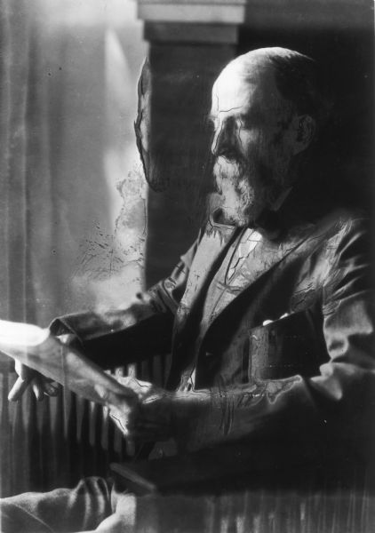 Portrait of Charles Franklin Gale, the father of novelist and playwright Zona Gale, reading a newspaper.