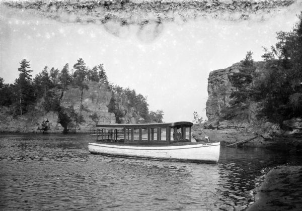 The skipper guides the motor launch <i>Miss Helen</i> on the Wisconsin River in the Dells.
