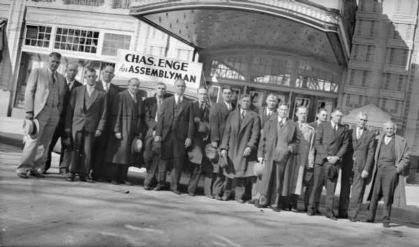 Charles Enge, seventh from left, and supporters pose in front of the Al. Ringling Theatre. A sign on top of a car advertises his campaign for the Wisconsin Assembly. Mr. Enge, a Sauk County farmer and Republican, served in the Assembly beginning in 1940.
