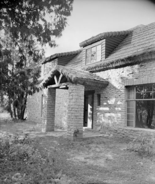 The entrance to "Place of Hawks," the home of author August Derleth, built in 1940. The stone house is roofed with a kind of thatch.