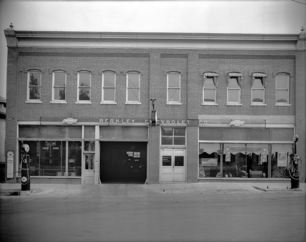 The Berkley Chevrolet dealership, 224 Third Avenue, housed in a two-story brick building with Red Crown Gasoline pumps in front. Signs in the window advertise different makes of Chevrolet automobiles, ranging in price from $510 to $765. The prices of Pathfinder Tires are also advertised.